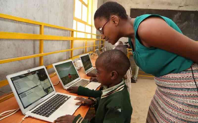 Cheboi supervises a young learner at her digita; lab.