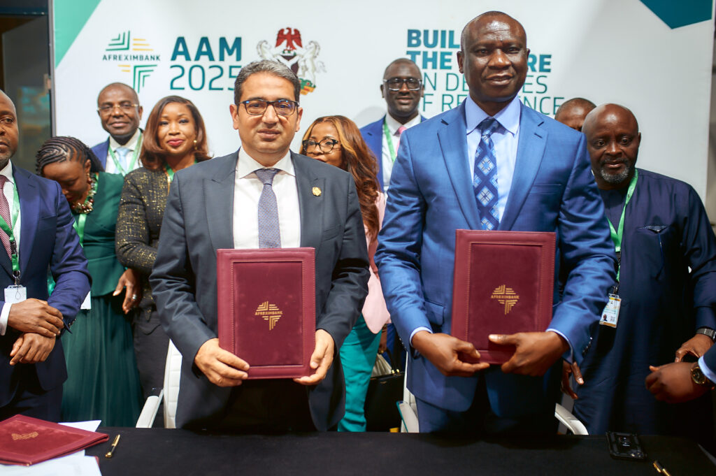 Haytham Elmaayergi, Executive Vice President, Global Trade Bank, Afreximbank (with folder, left) exchanges the signed agreement with Mr. Buah Saidy, Governor of Central Bank of The Gambia after the two organisations inked the deal at the 32nd Afreximbank's Annual Meetings in Abuja, Nigeria.